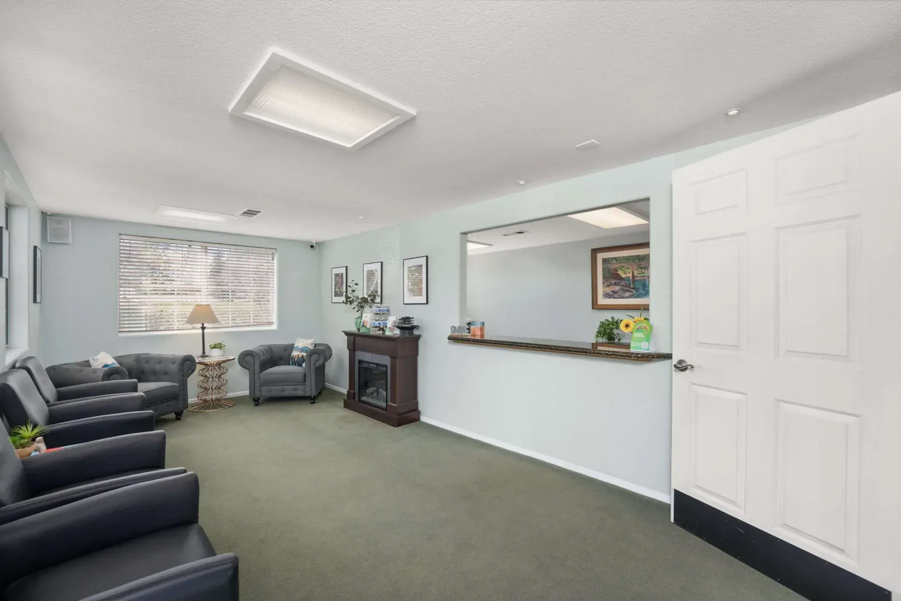 The waiting room with armchairs and a fireplace