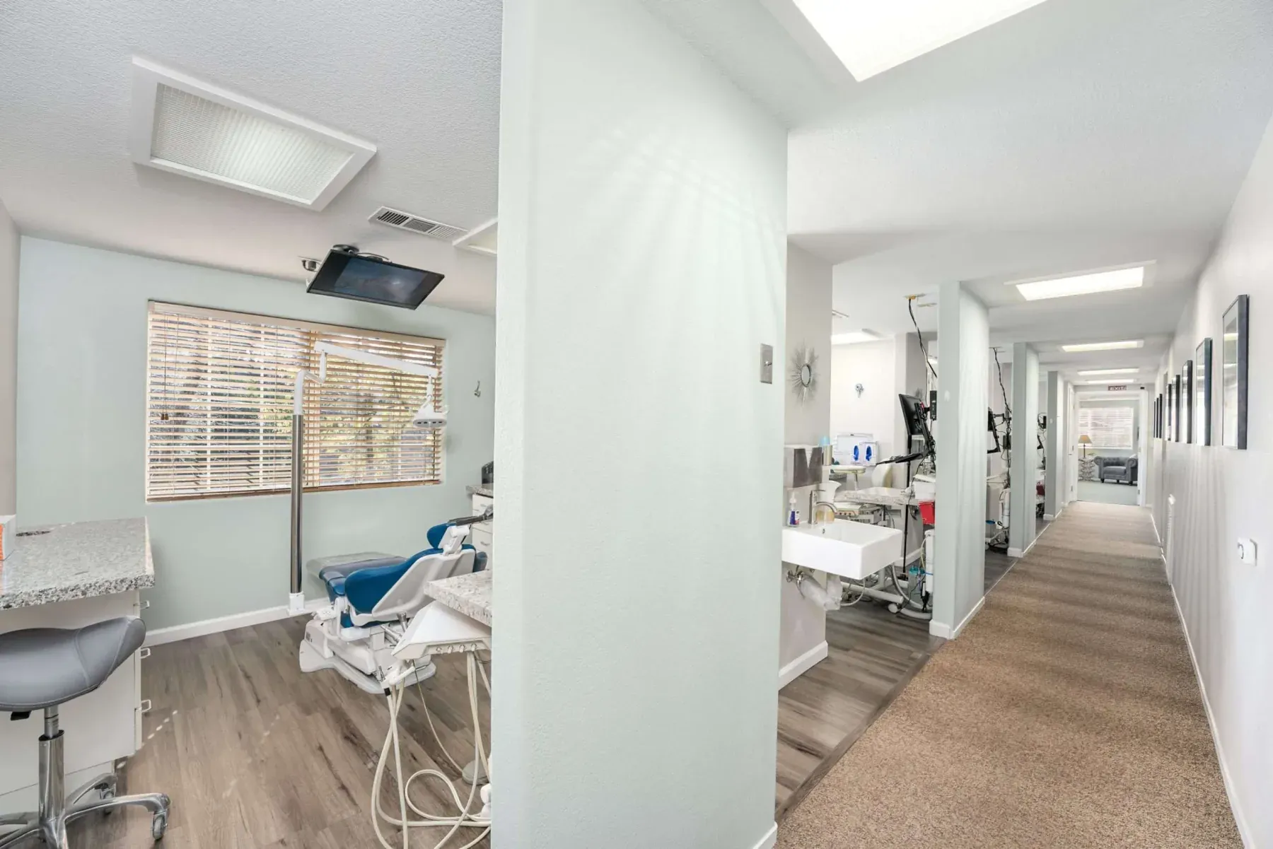 A treatment room opening onto the main hallway at Alta Vista Dental Care